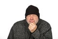 Contemplative Middle-Aged Worker in Black Winter Hat on White Background Feeling the Cold Royalty Free Stock Photo