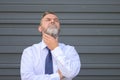 Contemplative senior businessman stroking his beard outdoors Royalty Free Stock Photo