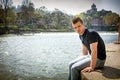 Contemplative teenage boy sitting beside river Royalty Free Stock Photo