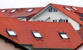 Modern residential buildings with natural red tiled roofs and skylights