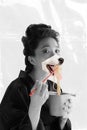 Contemporary art collage. Creative design. Beautiful young woman, geisha with dog's muzzle mouth eating noodles with