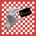 Contemporary art collage. Modern design with female hand holding black credit card isolated on red background with white Royalty Free Stock Photo
