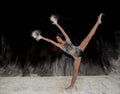 Contemporary ballet dancer dancing on the stage with flour