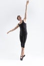 Contemporary Ballet Dancer Flexible Athletic Man Posing in Black Tights in Ballanced Dance Pose With Hands Lifted