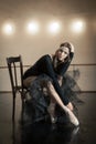 Contemporary ballet dancer on a wooden chair on a repetition