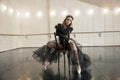 Contemporary ballet dancer on a wooden chair on a repetition