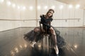 Contemporary ballet dancer on a wooden chair on a repetition