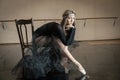 Contemporary ballet dancer on a wooden chair on a repetition