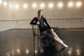 Contemporary ballet dancer on a wooden chair on a repetition