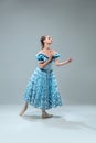 Contemporary ballroom dancer on grey studio background