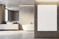 Contemporary bathroom design with freestanding bathtub, textured walls and white poster mockup. Royalty Free Stock Photo