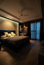 Contemporary bedroom interior with a dark-colored bed positioned in the center of the room