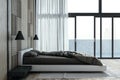 Contemporary bedroom interior with panoramic window and city view, curtain and other objects. Royalty Free Stock Photo