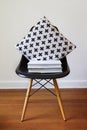 Contemporary black dining chair with modern crosses cushion