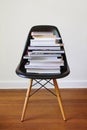 Contemporary black dining chair with stack of books