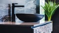 A contemporary black washbasin adding luxury to the Scandinavian bathroom decor