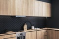 Contemporary black and wooden kitchen interior design.
