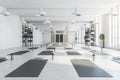 Contemporary bright white yoga studio gym interior with brick wall, window and city view. Royalty Free Stock Photo