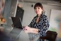 Contemporary, Brunette, Business woman working on laptop from home office Royalty Free Stock Photo