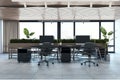 Contemporary concrete and wooden office interior with furniture and daylight, window and city view.