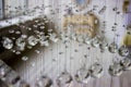 Contemporary crystal chandelier in room interior. Close up. Crystals suspended on a string. Crystal Chandelier