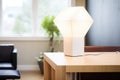 contemporary cubeshaped lamp with white light on minimalist table