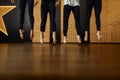 Contemporary dance studio, performers legs in jump