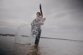 contemporary dancer in black clothes dancing in the sea Royalty Free Stock Photo