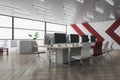 Contemporary designer coworking office interior with wooden flooring, furniture and window with city view.