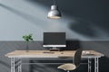Contemporary designer wooden desktop with empty computer screen, lamp, decorative plant, chair and concrete wall background. Mock Royalty Free Stock Photo