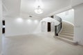 Contemporary foyer with marble floors, staircase, and abundant natural light in California Royalty Free Stock Photo