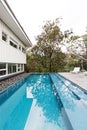 Contemporary fully tiled swimming pool in mid century modern home Royalty Free Stock Photo