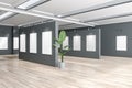 Contemporary gallery interior with empty white posters, mock up place and wooden flooring. Mock up