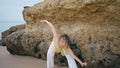 Contemporary girl dancing rocky shore bending flexible body. Talented dancer