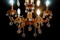 Contemporary glass chandelier isolated over black background. Chandelier for interior of the living room. Gold decoration Royalty Free Stock Photo