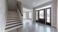 Contemporary home with minimal furnishings and decor light wood floor stairs white walls large windows with black frames Royalty Free Stock Photo