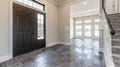 Contemporary home with minimal furnishings and decor light wood floor stairs white walls large windows with black frames Royalty Free Stock Photo