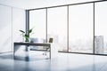 Contemporary home office interior with panoramic window and city view, workplace and sunlight. Royalty Free Stock Photo