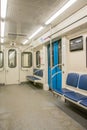 Contemporary inside space of the underground railway carriage with empty seats. Royalty Free Stock Photo