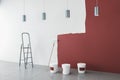 Contemporary interior with red paint on wall, painting tools, ladder, lamps and concrete flooring. Repairs concept. 3D