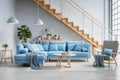 Contemporary living room with a large blue sofa and stylish wooden staircase Royalty Free Stock Photo