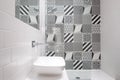 Contemporary loft bathroom with walk in shower unit and black and white monochrome porcelain wall tiles. Royalty Free Stock Photo