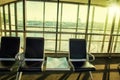Contemporary lounge with seats in the airport during sun set or