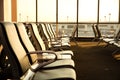 Contemporary lounge with seats in the airport during sun set or