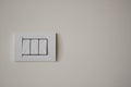 Contemporary modern electric light switches on on a light living room wall. House home utilities interior details elements Royalty Free Stock Photo