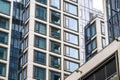 Contemporary multi-story building made of concrete and glass with strict geometric shapes and ledges and a repeating pattern of Royalty Free Stock Photo