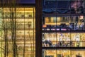 Contemporary office with an illuminated glazed facade at night in the financial district. Modern building typical in tech industry