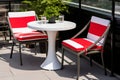 Contemporary outdoor patio bistro set with pops of red and white