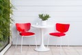 Contemporary outdoor patio bistro set with pops of red and white