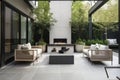 contemporary outdoor patio with sleek furniture, greenery and outdoor fireplace